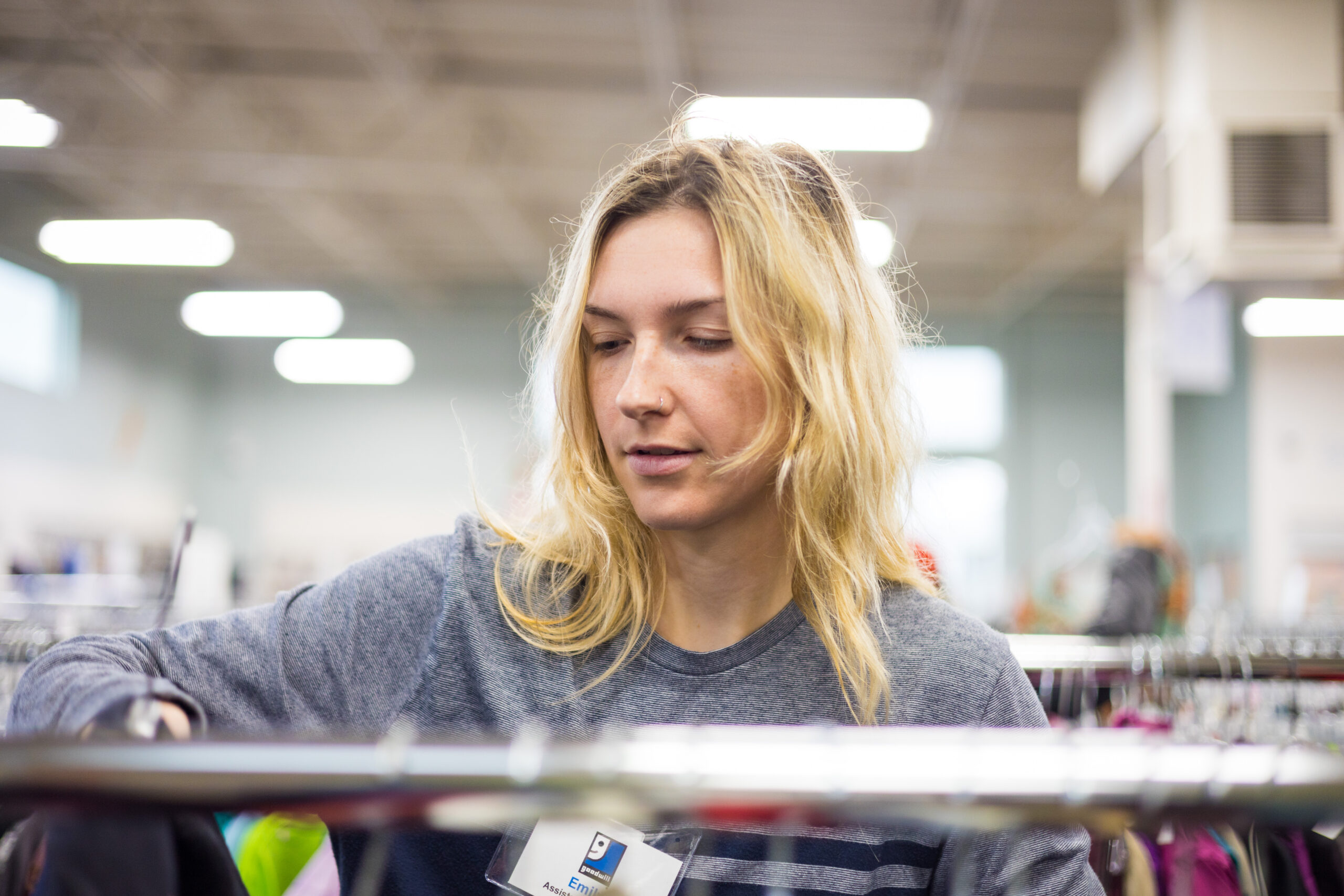 retail employee organizing clothes