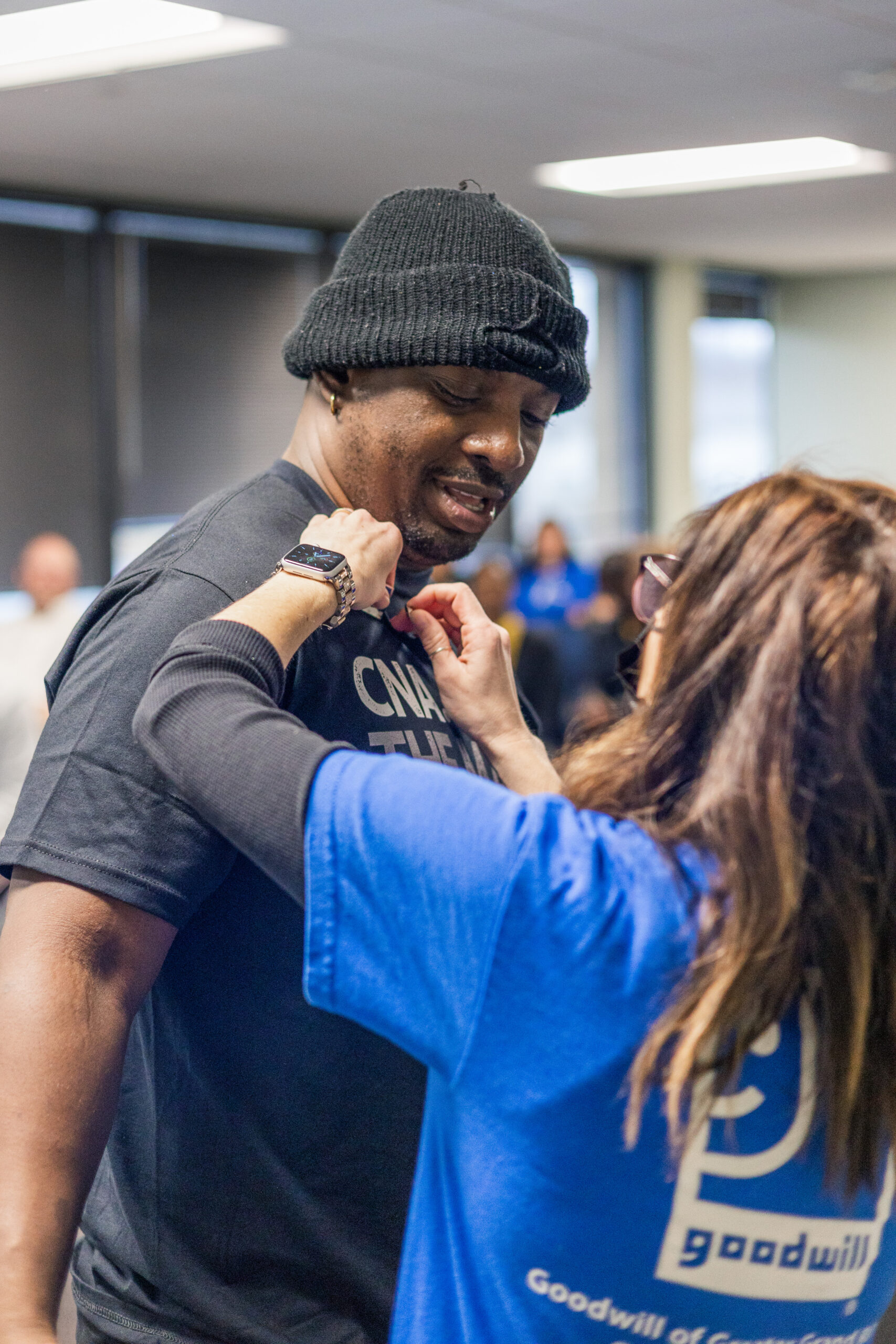 Man getting his CNA graduation pin