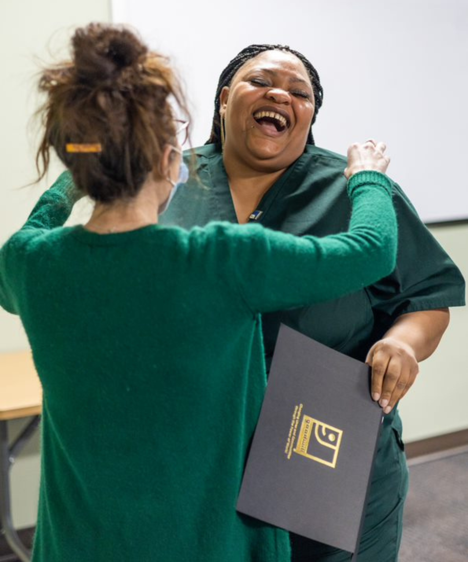 CNA graduation two women hugging