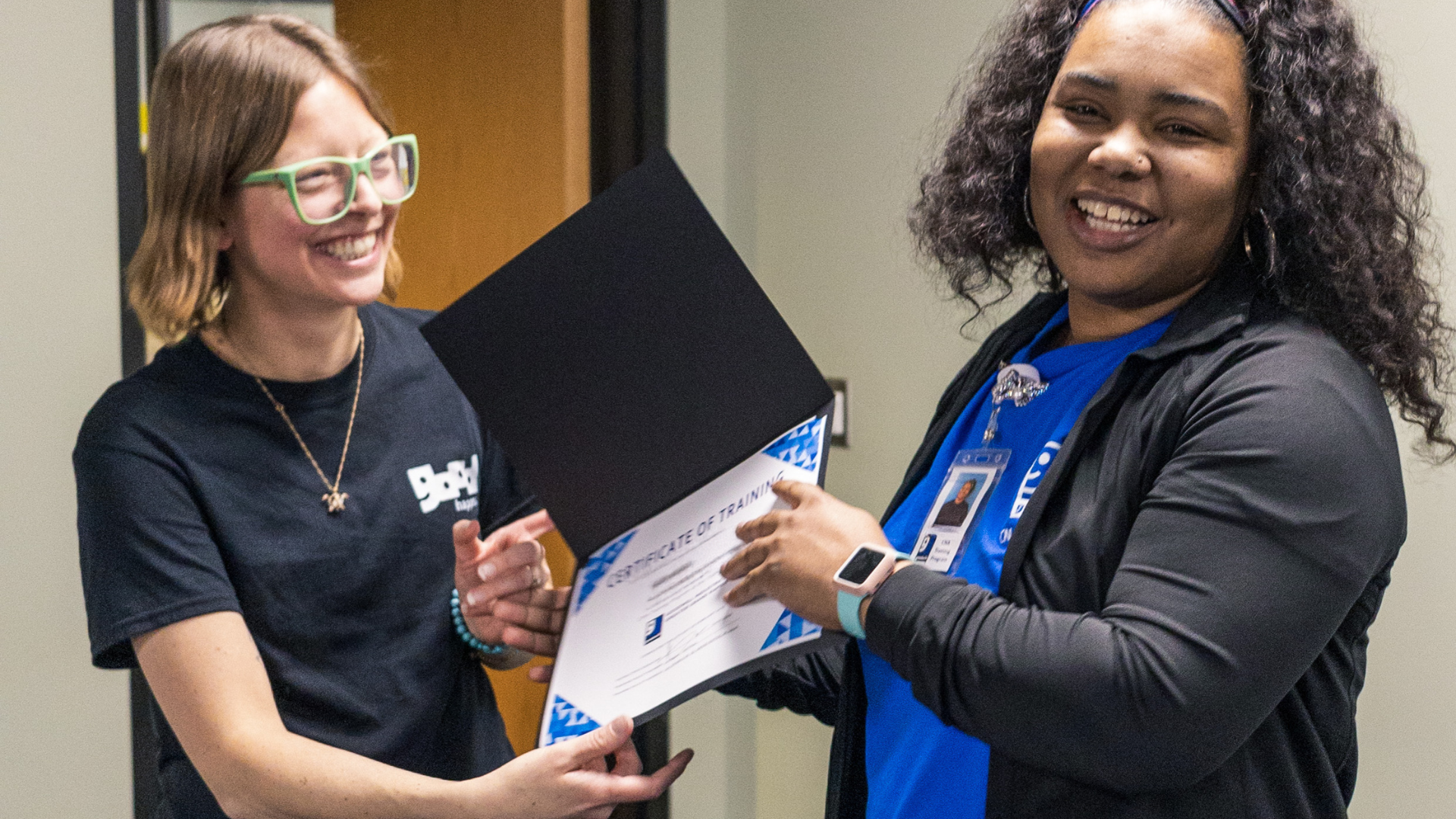 CNA Grad Woman accepting her CNA dipolma